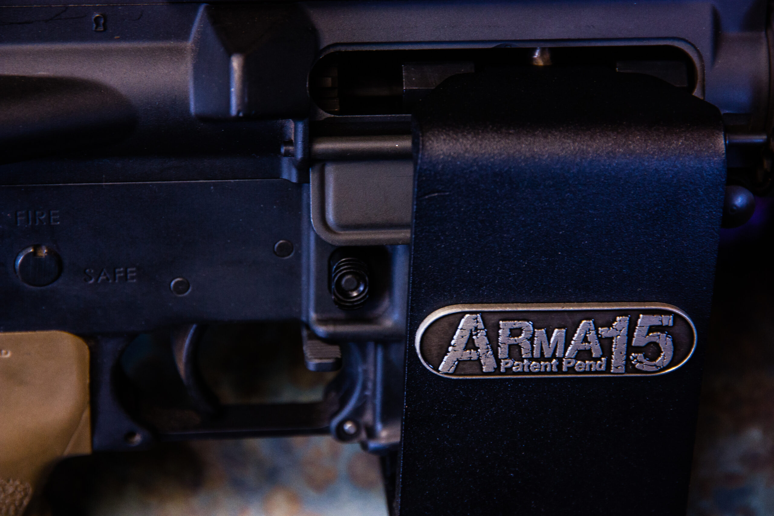 Close-up of the ARmA15 steel locking mount around an AR15 receiver, showing the ARmA15 badge.