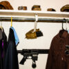 AR15 secured horizontally in an ARmA15 wall mount inside a closet behind hanging clothes.