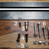 Chevy GMC truck mounting hardware numbered 1–7: support bar, rivnut, installation tool, bolts, washers and nuts; wall hardware sold separately
