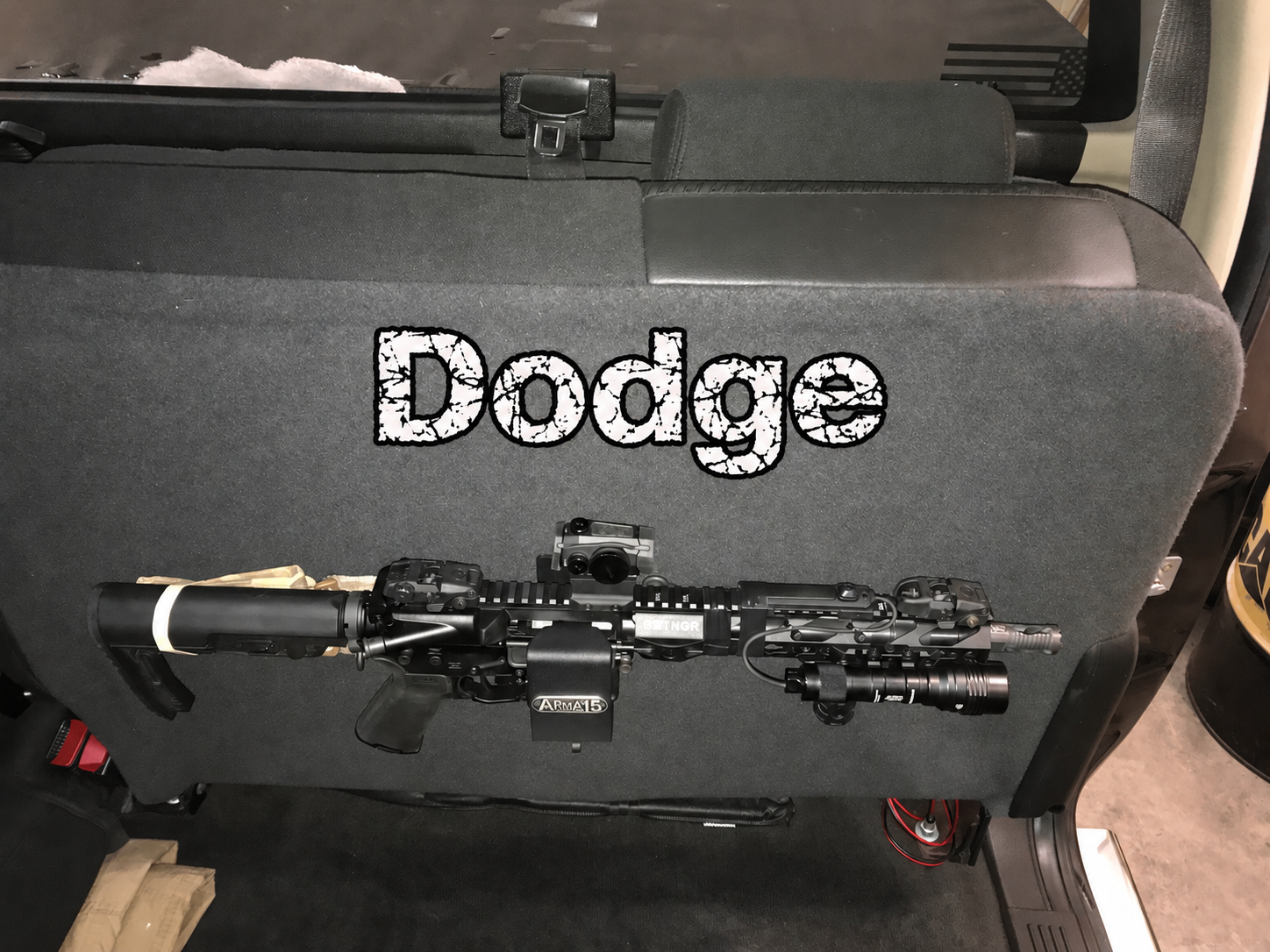Dodge truck ARmA15 mount — Gastada thumbnail ARmA15 rifle mount beneath a Dodge truck rear seat, with Dodge lettering above the rifle