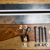 Dodge vehicle hardware — numbered parts 1–7 Dodge truck mounting hardware numbered 1–7: support bar, rivnut, installation tool, bolts, washers and nuts; wall hardware sold separately